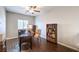 Home office featuring wood floors, a desk with a lamp, and built-in bookshelves at 9113 Sea Mink Ave, Las Vegas, NV 89149