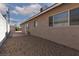 Exterior view of the home with a concrete patio and low-maintenance desert landscaping at 922 Westminster Ave, Las Vegas, NV 89119