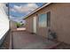 Side yard with concrete patio, leading to a low maintenance desert landscape at 922 Westminster Ave, Las Vegas, NV 89119