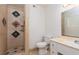 Bathroom with a uniquely tiled standing shower, vanity, and toilet at 922 Westminster Ave, Las Vegas, NV 89119