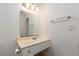Traditional bathroom with a granite countertop, vanity, mirror, and classic light fixture at 922 Westminster Ave, Las Vegas, NV 89119