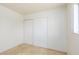 Neutral bedroom features a tiled floor, built-in closet and a bright window at 922 Westminster Ave, Las Vegas, NV 89119