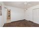 Bright bedroom featuring a ceiling fan, closet, and attached bathroom with stylish tile accents at 922 Westminster Ave, Las Vegas, NV 89119