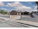 Cozy single-story home featuring a large front yard and covered parking area at 922 Westminster Ave, Las Vegas, NV 89119