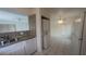 Kitchen area with stainless steel sink, white appliances, and a stacked washer/dryer at 922 Westminster Ave, Las Vegas, NV 89119