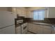 A well-lit kitchen showcasing white appliances, cabinets and granite countertops at 922 Westminster Ave, Las Vegas, NV 89119