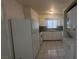 Bright kitchen featuring white appliances, granite countertops and tile flooring at 922 Westminster Ave, Las Vegas, NV 89119