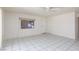 Bright living room with tile flooring, a ceiling fan, and natural light at 922 Westminster Ave, Las Vegas, NV 89119