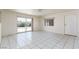 Bright living room featuring tile floors, ceiling fan and sliding glass door at 922 Westminster Ave, Las Vegas, NV 89119