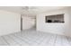 Spacious living room offers tile flooring, a ceiling fan, and an open view into dining area at 922 Westminster Ave, Las Vegas, NV 89119