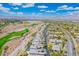 Scenic aerial shot highlights the homes along the golf course and the surrounding mountain landscape at 9233 Canyon Mesa Dr, Las Vegas, NV 89144