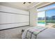 Bright bedroom with a large sliding glass door offering views of the pool and community at 9233 Canyon Mesa Dr, Las Vegas, NV 89144