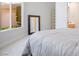 Bedroom view featuring a large window and mirror reflecting the home's bright interior at 9233 Canyon Mesa Dr, Las Vegas, NV 89144