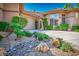 Landscaped front yard with desert rock garden and lush tropical foliage enhances the curb appeal of this lovely home at 9233 Canyon Mesa Dr, Las Vegas, NV 89144