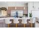 Modern kitchen island featuring a white countertop, stylish barstools, and a stunning view of stainless steel appliances at 9233 Canyon Mesa Dr, Las Vegas, NV 89144