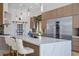 Modern kitchen with a spacious island, pantry, stainless steel appliances, and stunning white marble countertops at 9233 Canyon Mesa Dr, Las Vegas, NV 89144