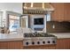 Gourmet kitchen featuring stainless steel appliances, custom cabinetry, quartz countertops, and an island at 9233 Canyon Mesa Dr, Las Vegas, NV 89144