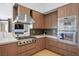 Gourmet kitchen featuring stainless steel appliances, custom cabinetry, and quartz countertops at 9233 Canyon Mesa Dr, Las Vegas, NV 89144