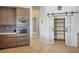 Kitchen boasts a pantry behind a sliding door, custom cabinets, stainless steel appliances, and hardwood floors at 9233 Canyon Mesa Dr, Las Vegas, NV 89144
