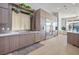 Gourmet kitchen featuring stainless steel appliances, custom cabinetry, quartz countertops, and an island at 9233 Canyon Mesa Dr, Las Vegas, NV 89144