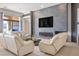 Comfortable living room features a stone accent wall, a cozy electric fireplace, and large couches at 9233 Canyon Mesa Dr, Las Vegas, NV 89144