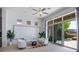 Inviting living room with white walls, stylish décor, and large sliding glass doors leading to a patio at 9233 Canyon Mesa Dr, Las Vegas, NV 89144