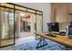 Inviting home office with an indoor/outdoor feel with sliding glass doors to the patio at 9233 Canyon Mesa Dr, Las Vegas, NV 89144