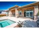 Covered back patio with a built-in grill, bar and pool access, perfect for outdoor gatherings and relaxation at 9233 Canyon Mesa Dr, Las Vegas, NV 89144