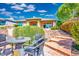 Back patio features a patio furniture set and stone pavers with lush bushes, perfect for relaxing and entertaining at 9233 Canyon Mesa Dr, Las Vegas, NV 89144