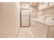 A dedicated laundry room with ample storage cabinets, a refrigerator, and a washer/dryer at 940 Vegas Valley Dr, Las Vegas, NV 89109