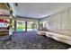 Spacious living room with views of the pool from the expansive windows at 940 Vegas Valley Dr, Las Vegas, NV 89109