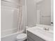 A clean bathroom with a toilet, tub, shower, and vanity sink at 10058 Matter Overlook Dr, Las Vegas, NV 89178