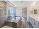 Spacious bathroom with double vanity, shower, and separate bathtub at 10058 Matter Overlook Dr, Las Vegas, NV 89178