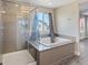 A modern bathroom featuring a glass shower and soaking tub combo at 10058 Matter Overlook Dr, Las Vegas, NV 89178