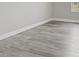 A close up of the gray wood look floors and baseboards at 10058 Matter Overlook Dr, Las Vegas, NV 89178