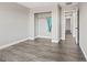 Bedroom features stylish gray wood flooring, white trim, neutral walls and an open closet at 10058 Matter Overlook Dr, Las Vegas, NV 89178