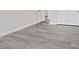 Bedroom features stylish gray wood flooring, white trim, and neutral walls at 10058 Matter Overlook Dr, Las Vegas, NV 89178