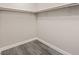 A simple walk in closet with gray wood look floors and room for storage at 10058 Matter Overlook Dr, Las Vegas, NV 89178
