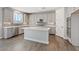 Open kitchen with white cabinets, stainless steel appliances, and kitchen island at 10058 Matter Overlook Dr, Las Vegas, NV 89178