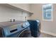 A clean laundry room area with modern washer and dryer units at 10058 Matter Overlook Dr, Las Vegas, NV 89178