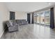 Living room with hardwood floors and large windows with backyard views at 10058 Matter Overlook Dr, Las Vegas, NV 89178