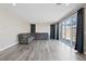 Bright living room featuring hardwood floors and large windows at 10058 Matter Overlook Dr, Las Vegas, NV 89178