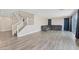 Open-concept living room with hardwood floors and large windows at 10058 Matter Overlook Dr, Las Vegas, NV 89178