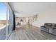 Bright living room with hardwood floors transitions to a modern kitchen and backyard patio at 10058 Matter Overlook Dr, Las Vegas, NV 89178