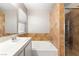 Bathroom features a soaking tub with tiled walls and a shower with glass door at 1125 Lumina Ct, Las Vegas, NV 89117