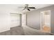 Bedroom with a ceiling fan, closet, neutral-toned walls, and an ensuite bathroom at 1125 Lumina Ct, Las Vegas, NV 89117