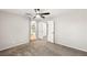 Spacious bedroom with plush carpeting, ceiling fan, and ensuite bathroom access at 1125 Lumina Ct, Las Vegas, NV 89117