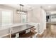 Light-filled dining area features built-in bench seating and modern chandelier at 1125 Lumina Ct, Las Vegas, NV 89117