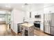 Renovated kitchen features stainless steel appliances, white cabinetry and modern finishes at 1125 Lumina Ct, Las Vegas, NV 89117