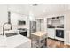 Bright kitchen with white cabinets, stainless steel appliances, island and built in laundry closet at 1125 Lumina Ct, Las Vegas, NV 89117